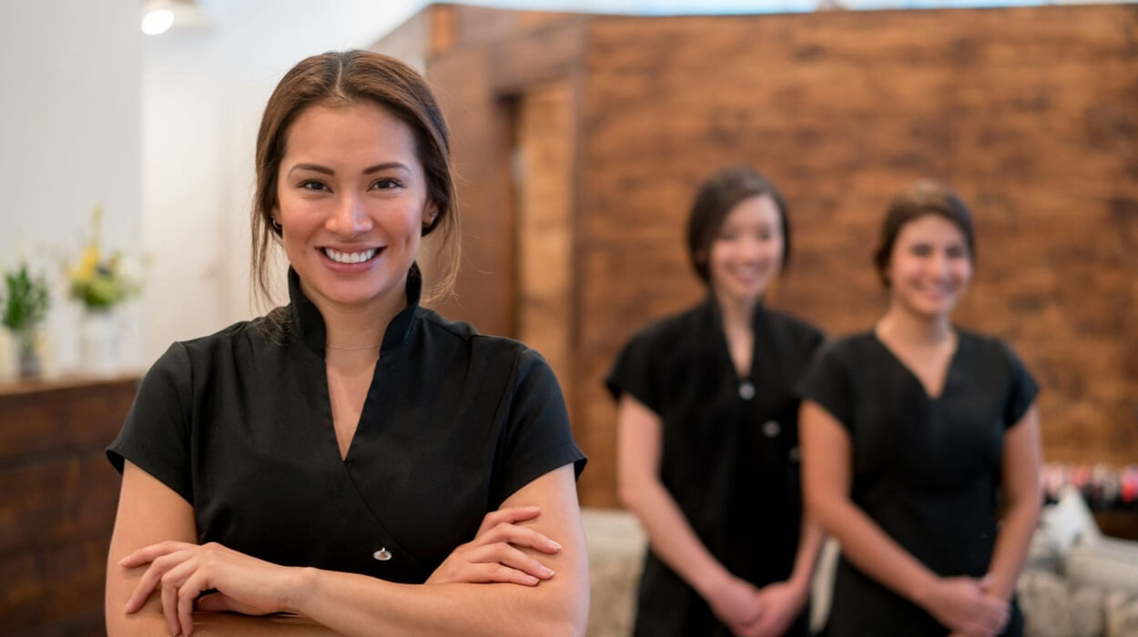 Medspa employees smiling in their front office